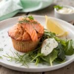 Serving muffin salmon with greens and lemon